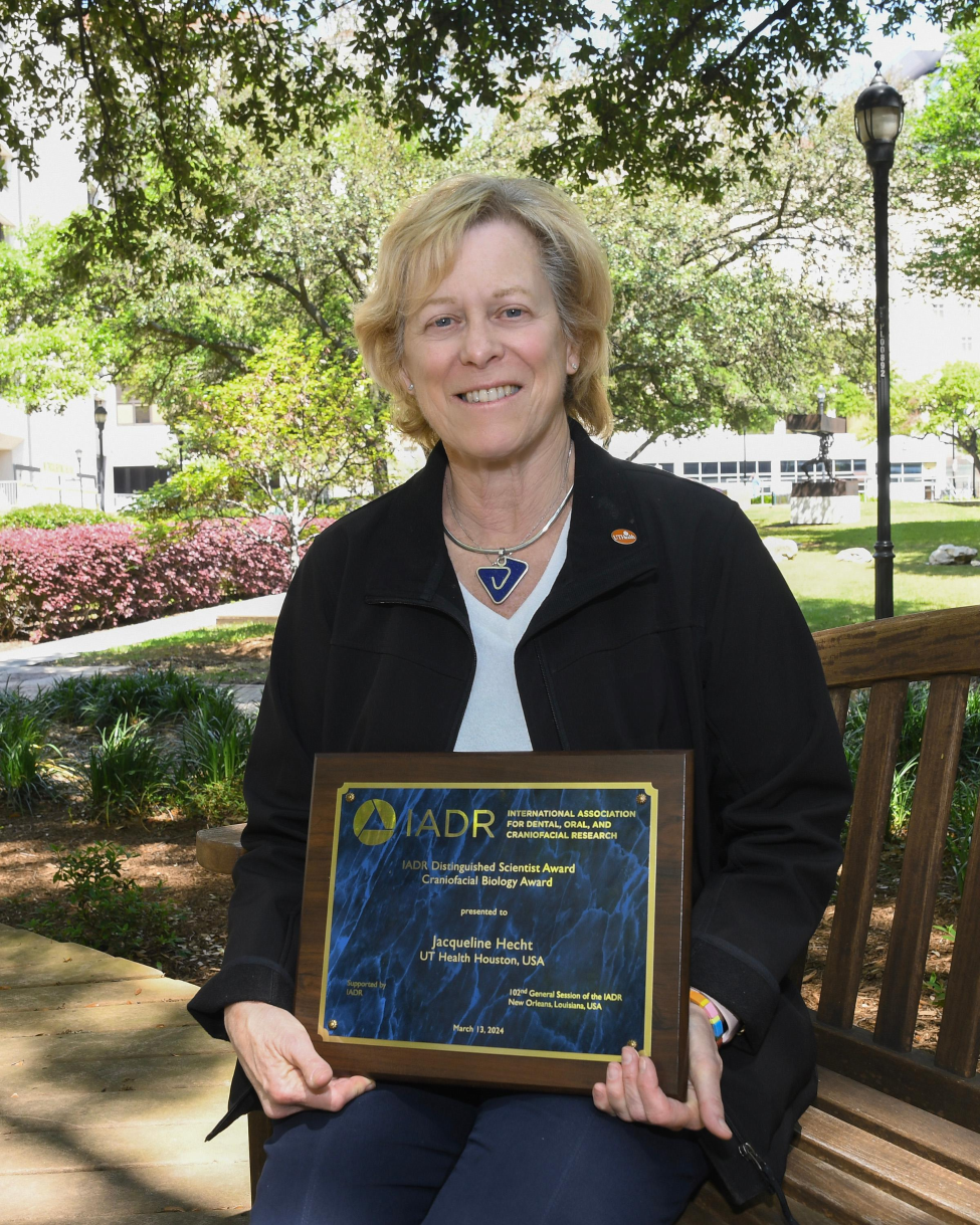 Dr. Jacqueline Hecht with her Distinguished Scientist Award in Craniofacial Biology Research by the International Association for Dental, Oral, and Craniofacial Research.