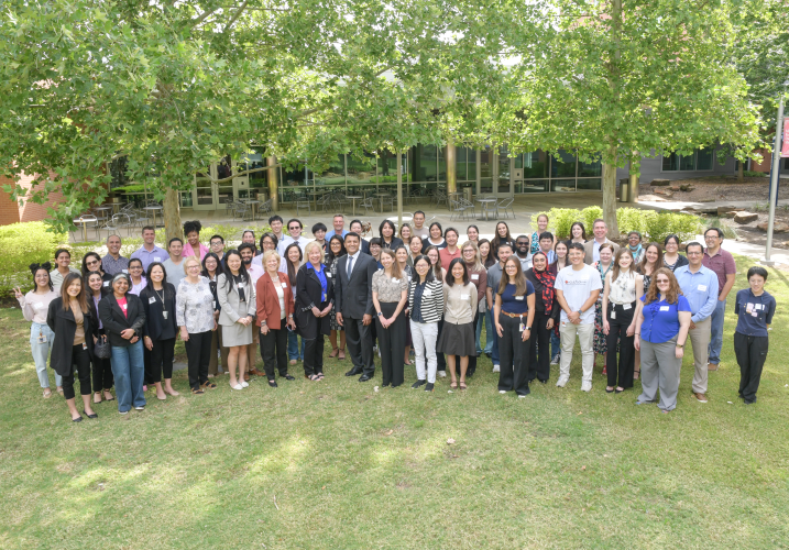 Large, outside group photo of academic retreat attendees.