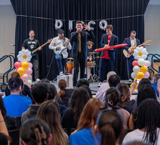 Band performs on stage in front of a crowd.