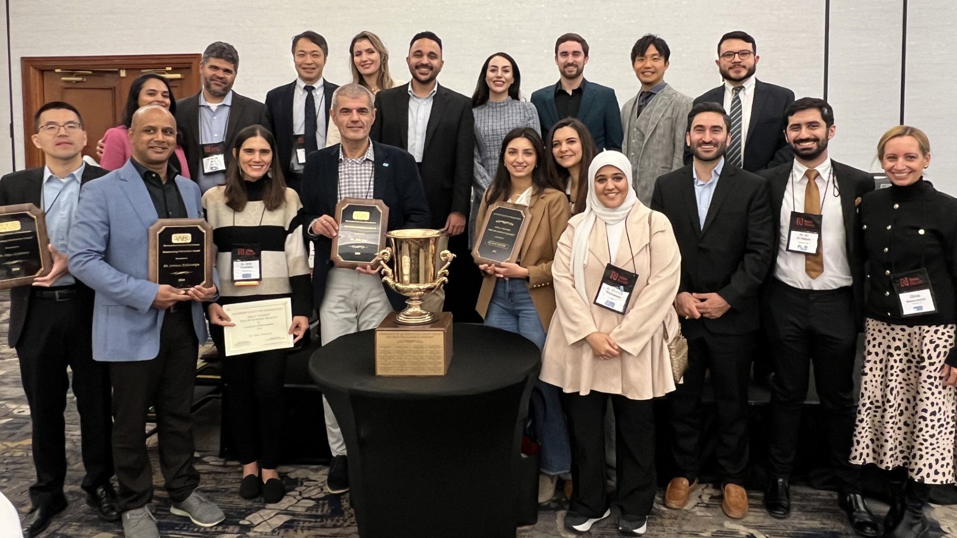 Large group of award winners in professional dress.