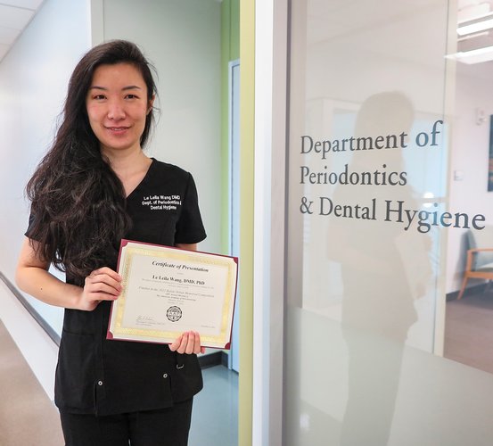 Le Leila Wang, DMD, PhD, a third-year resident, holds her finalist certificate for the basic science category in the 2022 Balint Orban Memorial Competition.