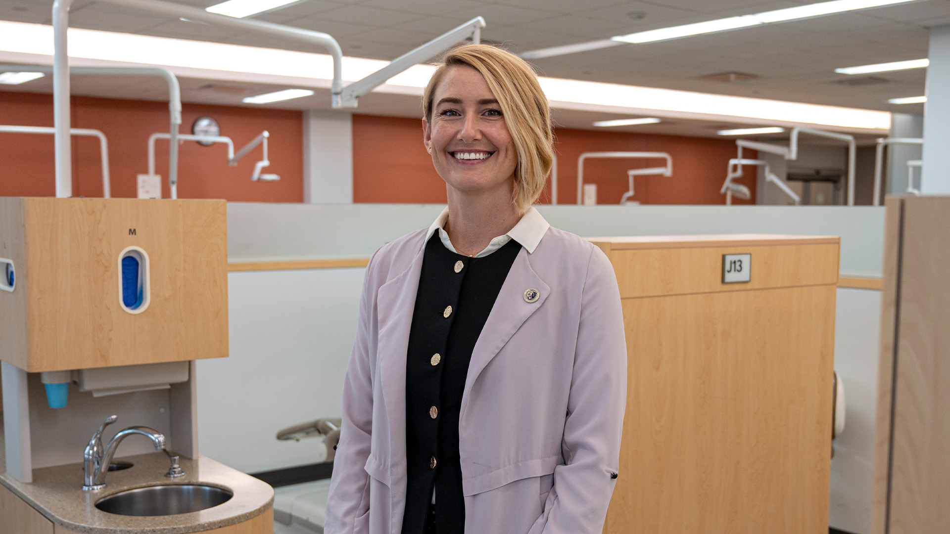 Women stands in a clinical setting.