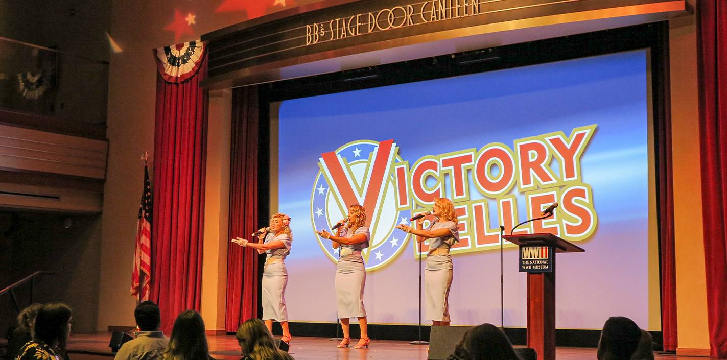 Trio of women perform on stage.