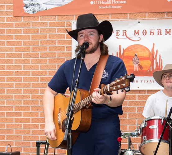 Dental student Cooper Mohrmann performs at UTHealth Houston School of Dentistry's 10 Year BBQ Celebration in 2022 as a first-year dental student with his band, Cooper Mohrmann & Company.