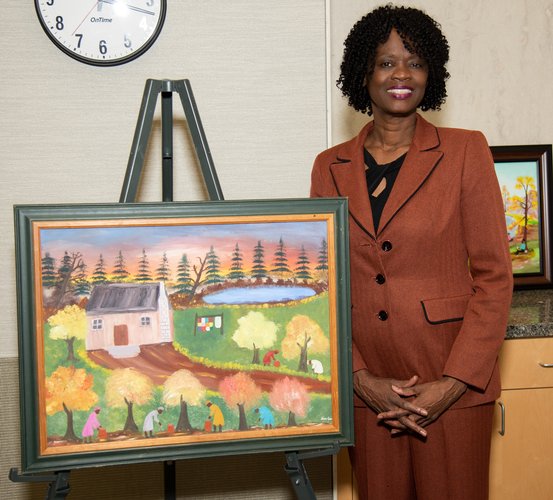 Lisa D. Cain, PhD, poses with a self-created painting at the Artistic Expressions Exhibit during UTHealth Houston School of Dentistry's 5th Annual Diversity, Equity, and Inclusion Week.