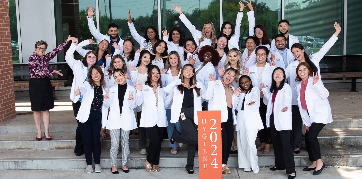Members of the Dental Hygiene Class of 2024 gather for a group photo on the front steps of UTHealth Houston School of Dentistry. Photo by Brian Schnupp.