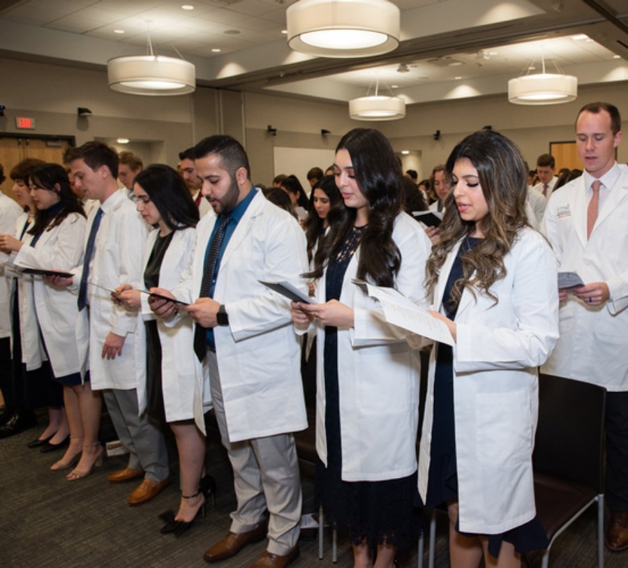 Group of dental students read The Dentist's Pledge during 24th Annual DDS White Coat Ceremony.