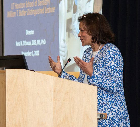 Woman speaks at a podium.