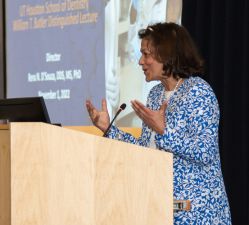 Woman speaks at a podium.