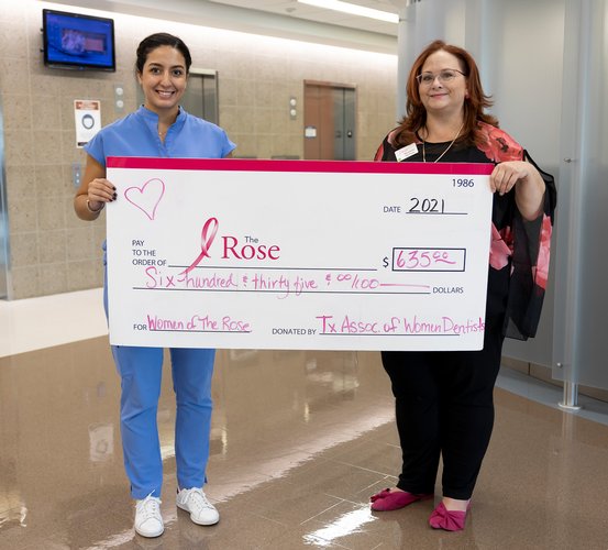 TAWD Chapter President Rebecca Trevino presents a $635 check to Shannon McNair of The Rose on Oct. 25.