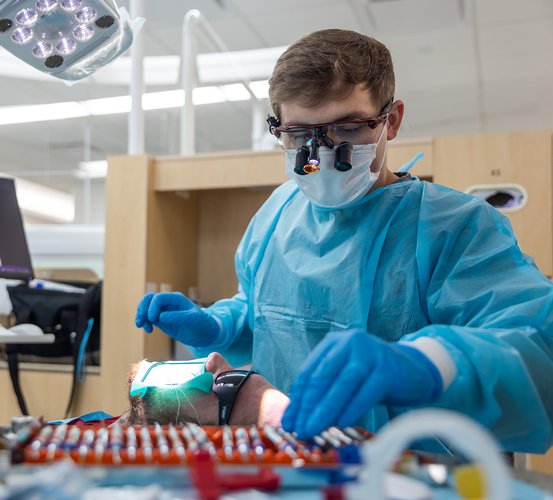 Fourth-year dental student Thaylan Bowman provides care to a veteran during the 8th Annual Give Vets a Smile at UTHealth Houston School of Dentistry.