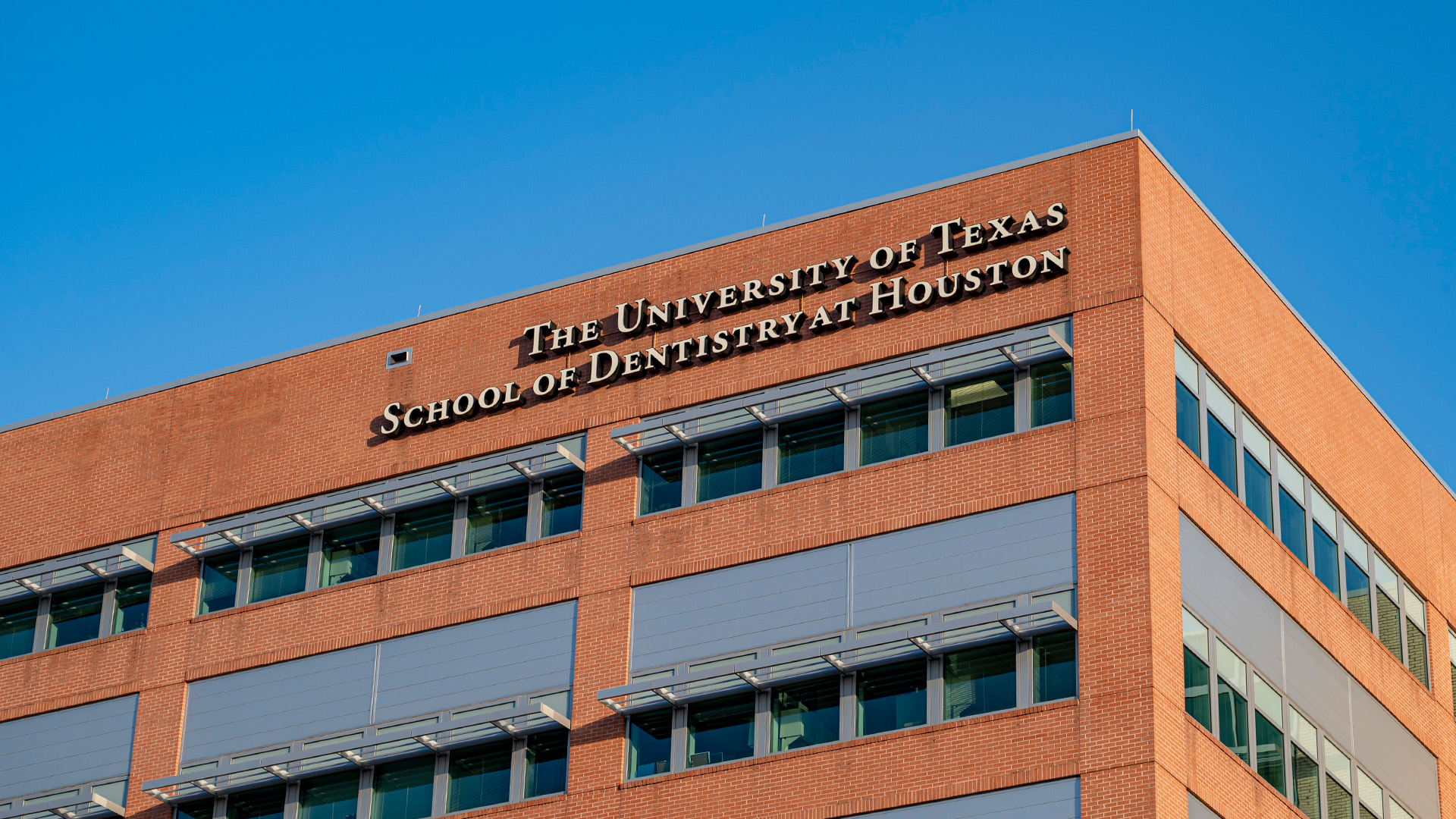 Exterior of UTHealth Houston School of Dentistry. Lettering on the building says The University of Texas School of Dentistry at Houston.