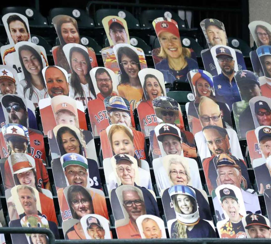 Life-size color photos of Astros fans seated  in a stadium
