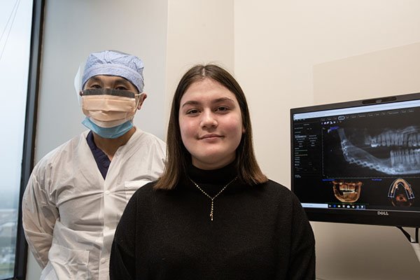Photo of Grace Moss with James Melville, DDS. Melville reconstructed Grace's jaw using tissue engineering. (Photo by Rogelio Castro/UTHealth)