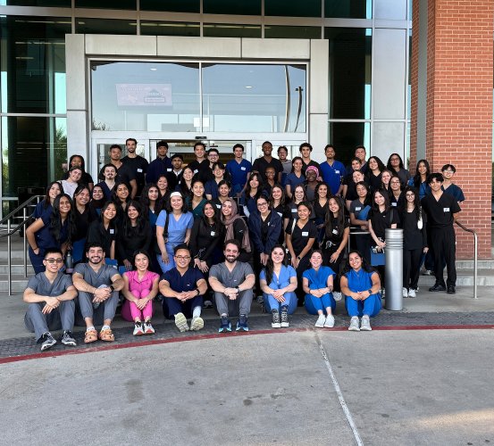 Large group photo on stairs in front of a building.