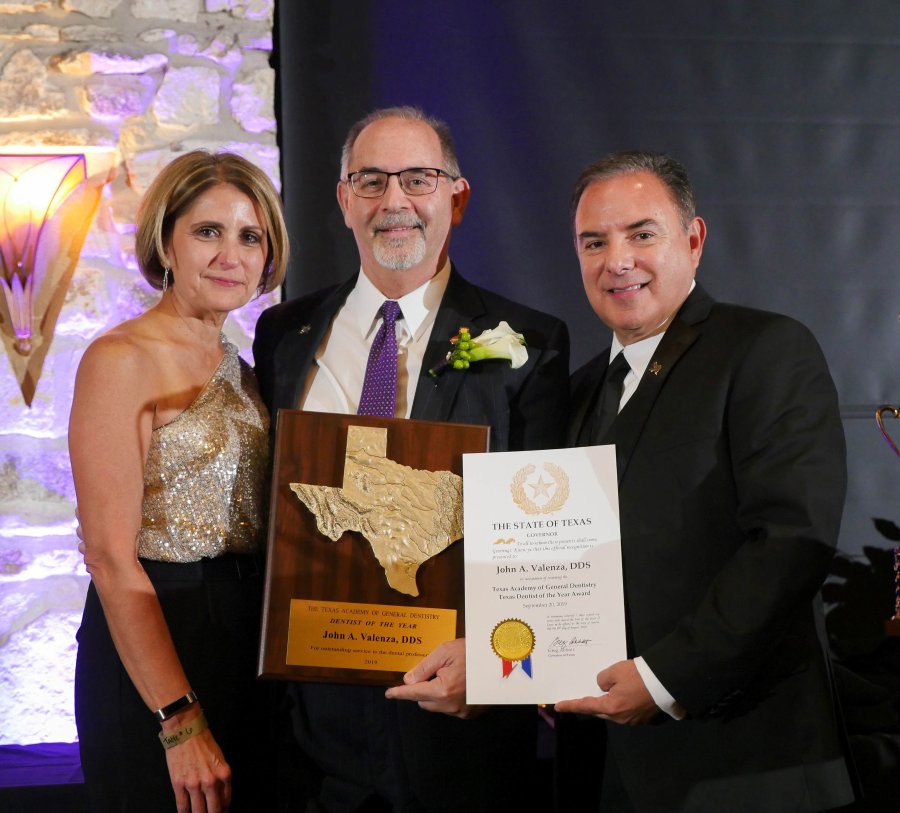 ean John Valenza, DDS, is the TAGD's 2019 Texas Dentist of the Year. He is pictured with his wife, Debbie Valenza, and the 2018 winner, Jose Cazares, DDS, of McAllen.