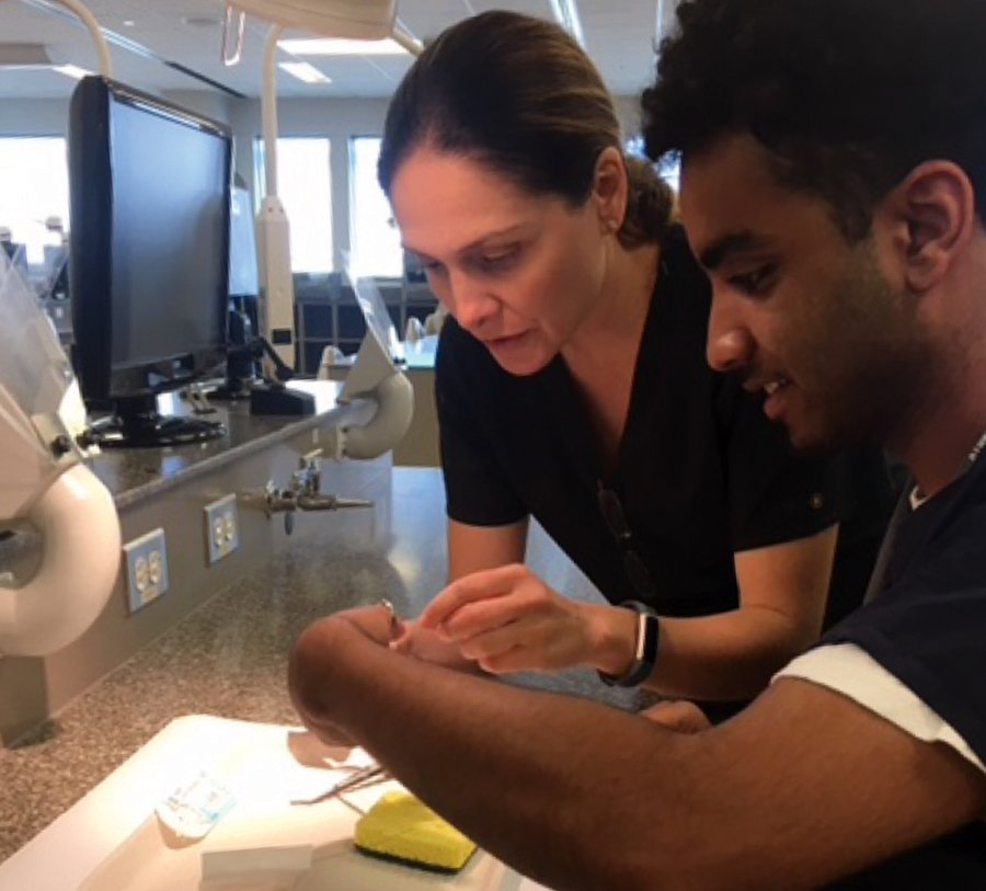 Dr. Shalizeh “Shelly” Patel (left) of UTSD and a SHPEP 2019 scholar practice suture techniques on a sponge (simulated wound).