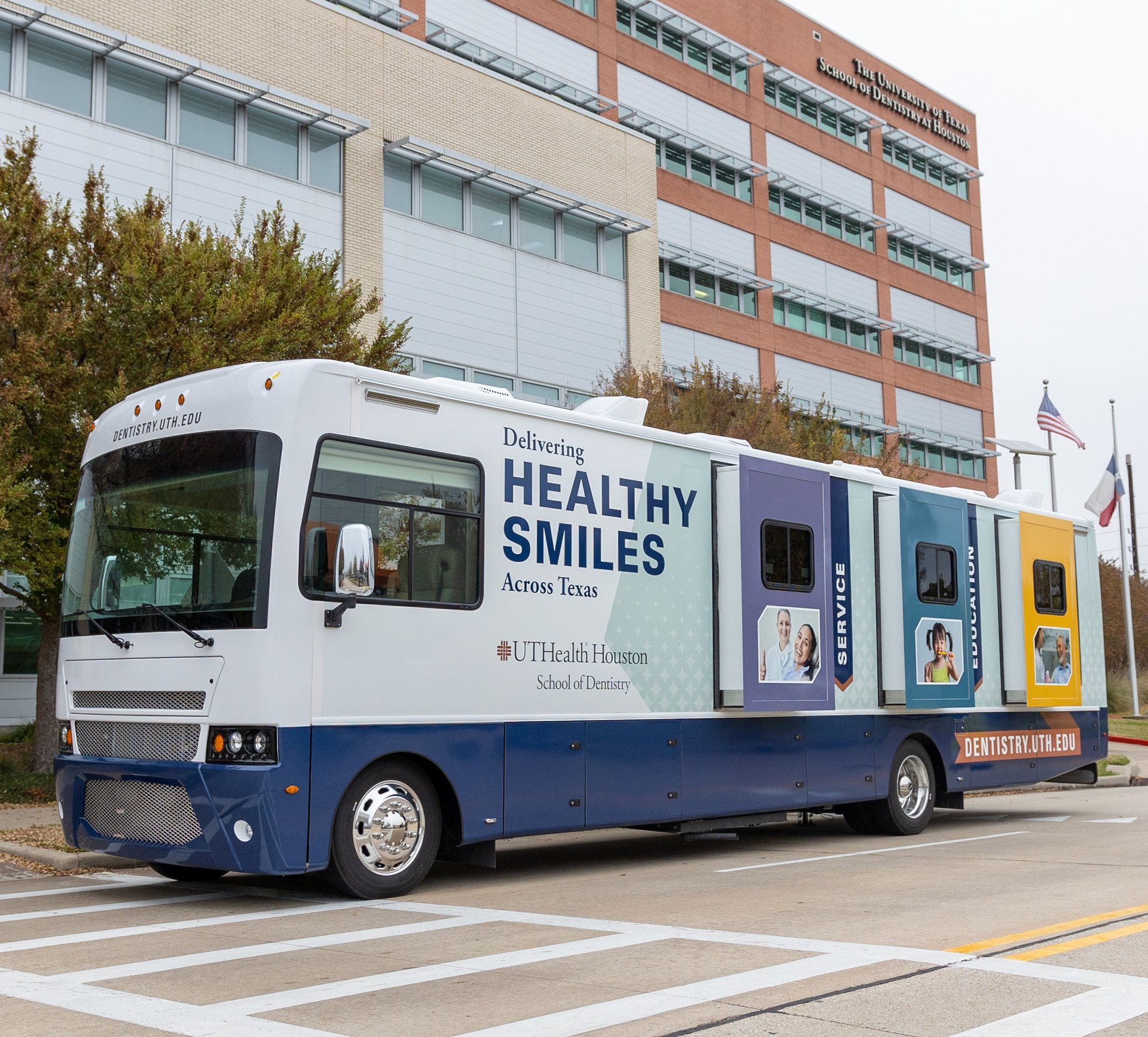 The mobile dental van parked in front of UTHealth Houston School of Dentistry.