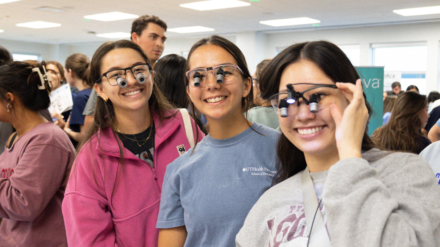 Students gathered indoors during the Loupes Fair event, with several attendees standing in line and holding items.