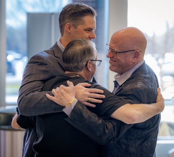 Drs. Jay Elliott and Kyle Hale surprise Dr. Stephen Laman with the presentation of a framed certificate of the scholarship established by their families in his name.