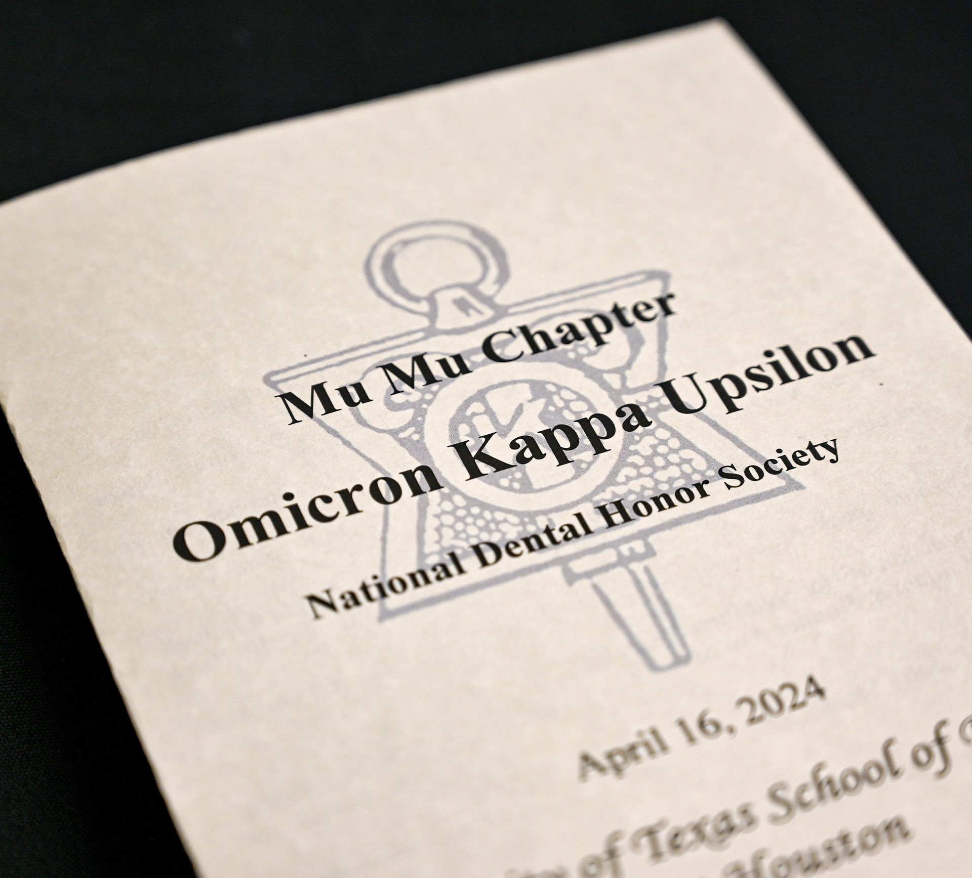 Photo of the 2024 induction program for the Omicron Kappa Upsilon National Dental Honor Society’s Mu Mu Chapter.