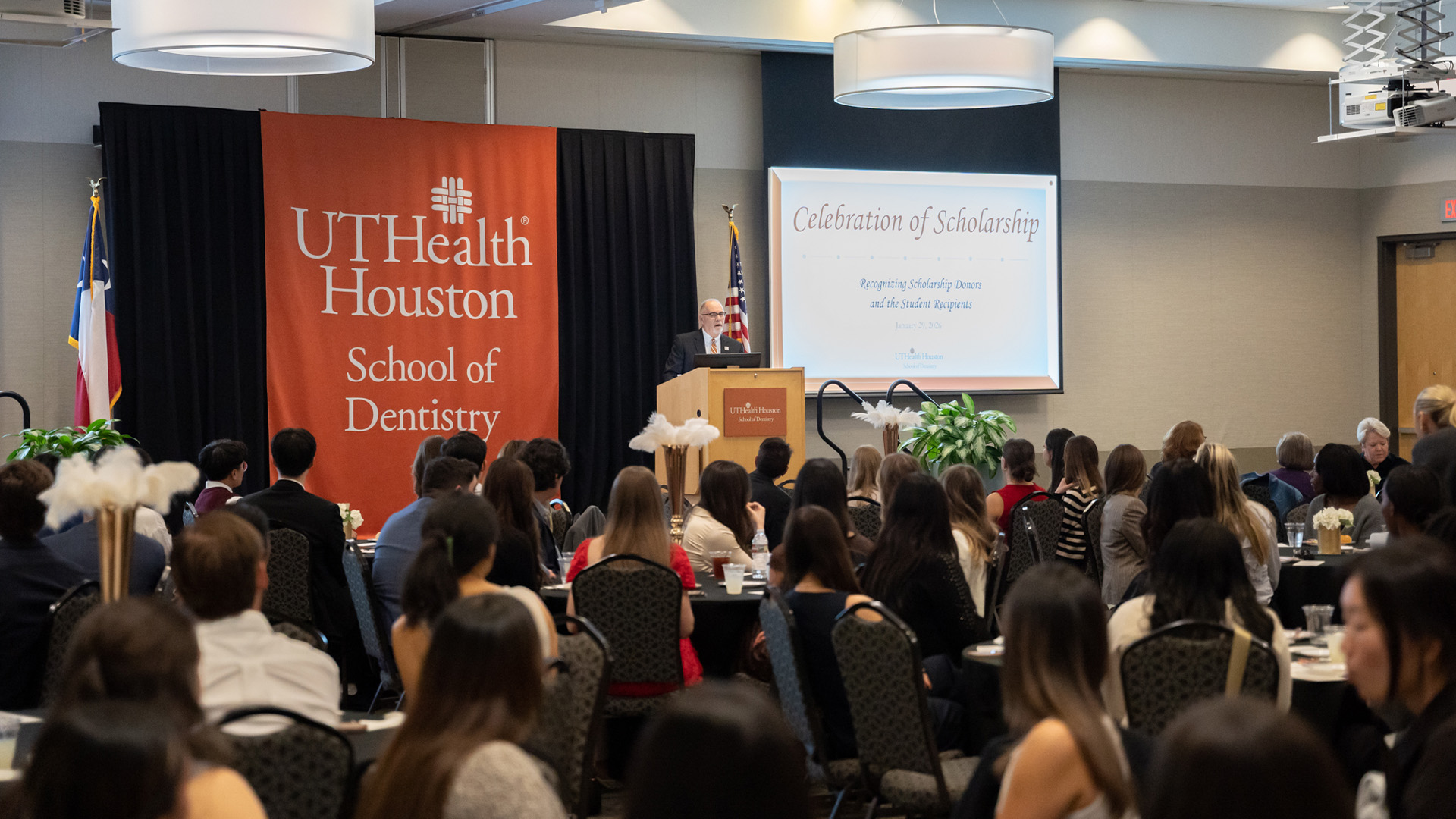 An event speaker addresses a seated audience at UTHealth Houston School of Dentistry.