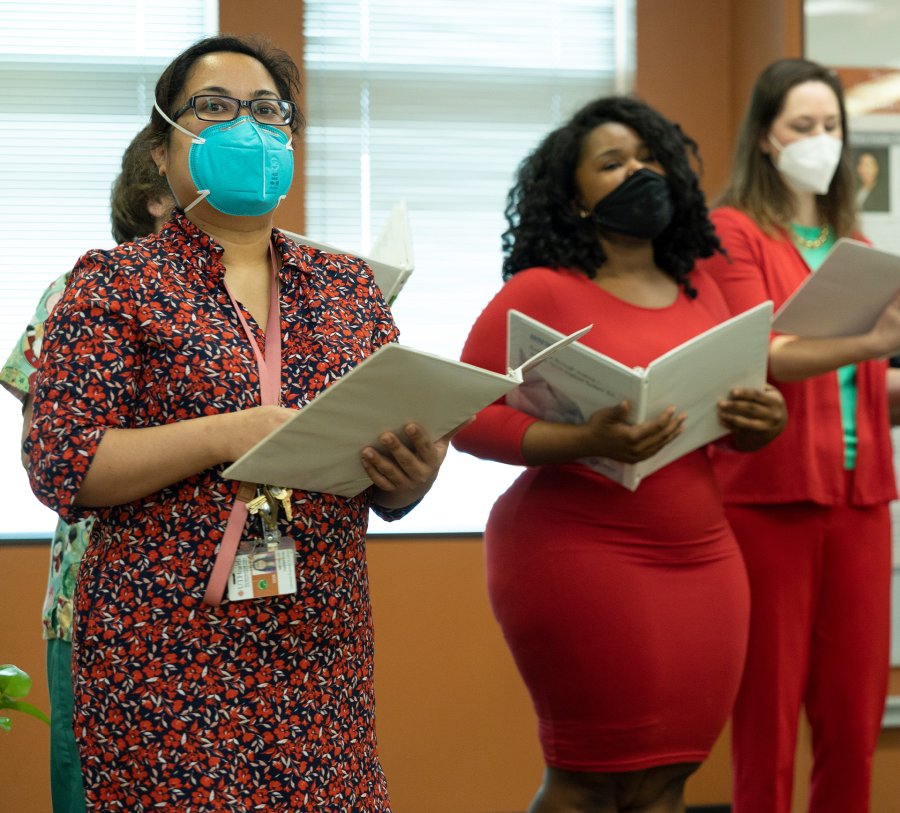 Dr. Michelle Thompson (left) sings with her choirmates, The Lingual Grove, during a holiday concert Friday, Dec. 10, at UTHealth Houston School of Dentistry.