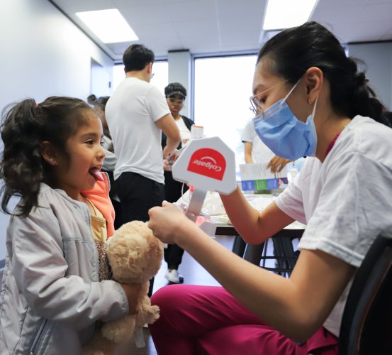 First-year dental hygiene student Amanda Pham demonstrating proper oral hygiene during the 2024 Community Health Fair at UT Physicians Multispecialty - Jensen.