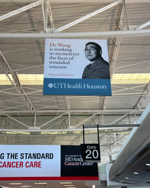 Banner hung inside an airport corridor.