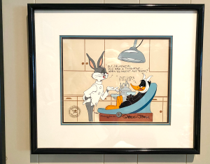 The first piece that the Oelfkes collected was created by well-known Warner Bros. animator Chuck Jones. It portrayed Bugs Bunny as a dentist, treating Daffy Duck. Photo courtesy of Gregory Oelfke, DDS '77.