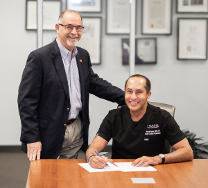 Dr. Raouf J. Hanna (right), pictured with Dean John A. Valenza, DDS, signs an endowment agreement with UTHealth Houston School of Dentistry. Photo by Brian Schnupp.