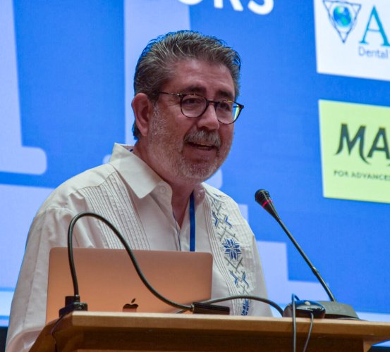 Man stands at a podium speaking into the microphone.