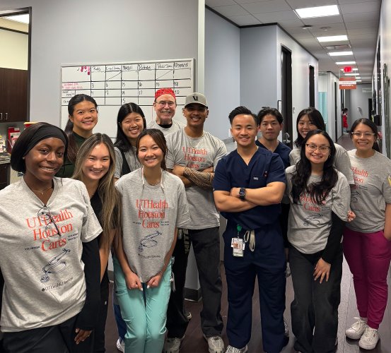 Group of dental school volunteers pose for a group photo.