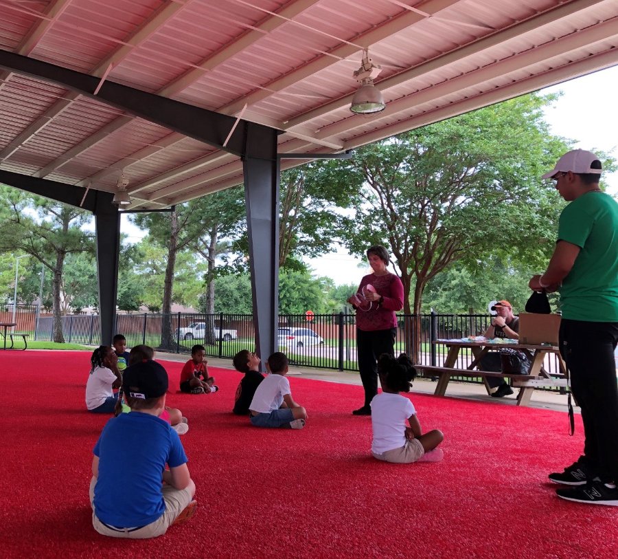 Dr. Debra Stewart teaches oral hygiene in an open-air pavilion at a local YMCA site, where the children were seated far apart to reduce the risk of spreading COVID-19.