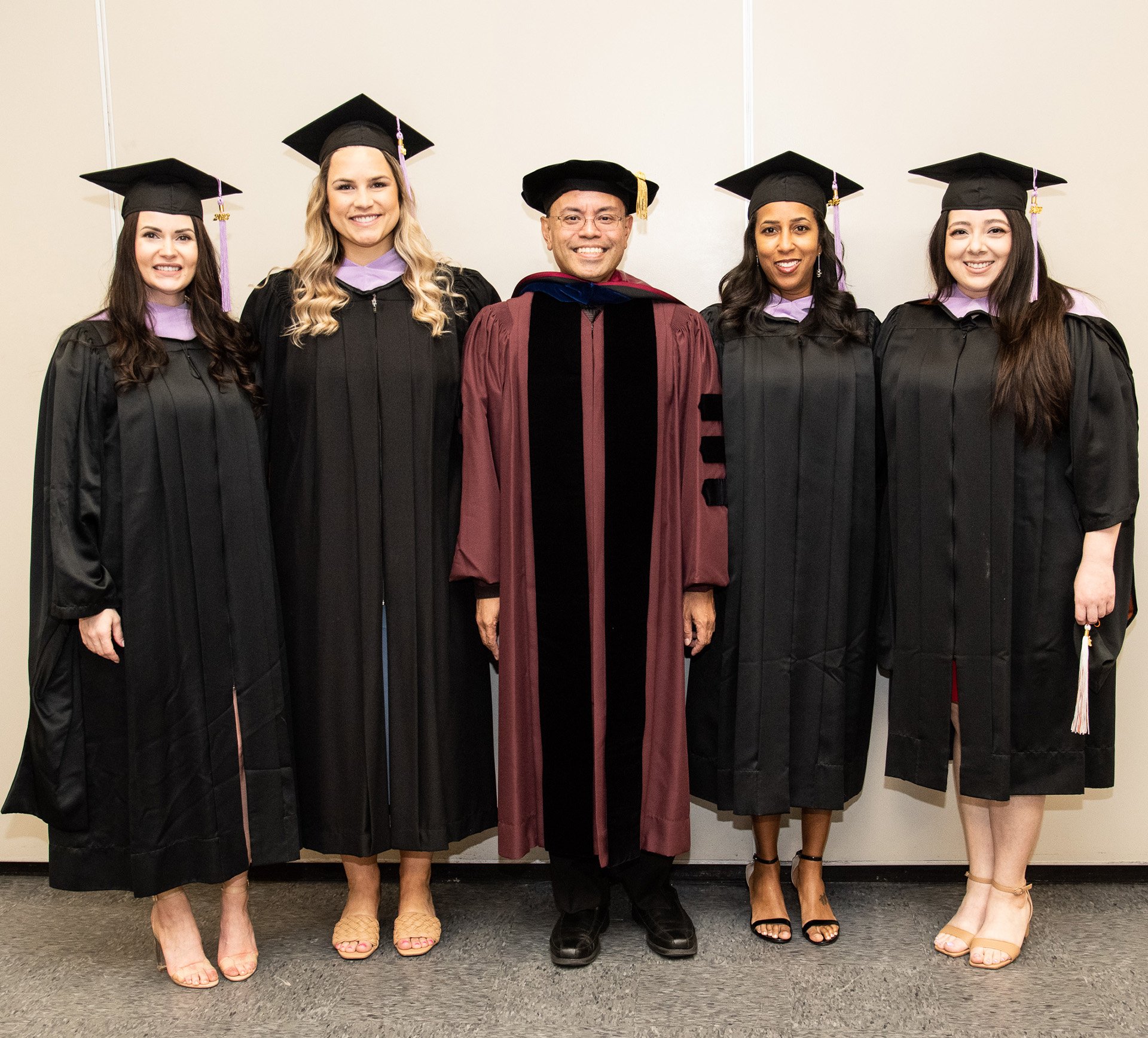 The four-member Master of Science in Dental Hygiene Class of 2023 stand with program coordinator Harold A. Henson, RDH, PhD.