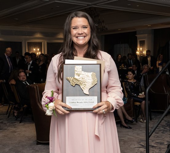 Dr. Lindsey Wendt holds her Texas New Dentist of the Year plaque after being announced as the 2022 recipient at the “Texas Academy Awards.”