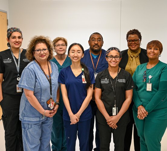 Group photo of individuals seated in a laboratory.