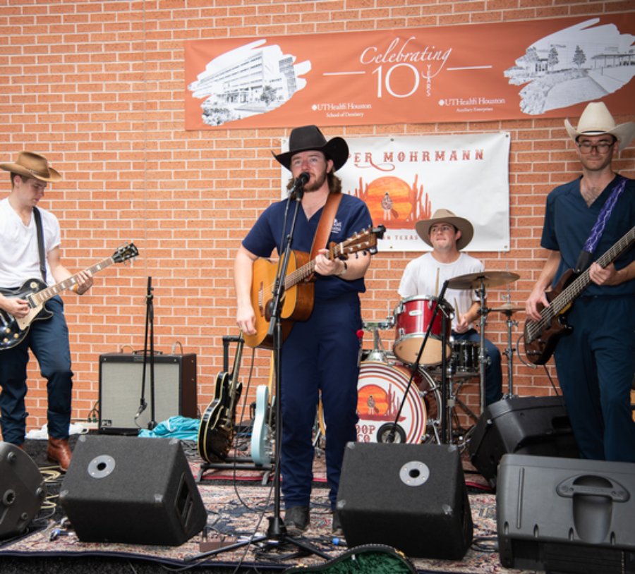 Dental student Cooper Mohrmann (center) and his band, Cooper Mohrmann & Company, perform at the 10 Year BBQ Celebration, hosted by the School of Dentistry and Auxiliary Enterprises on June 8, 2022.