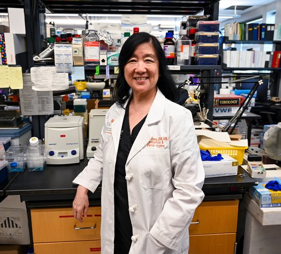 Dr. Bing-Yan Wang poses in her laboratory.