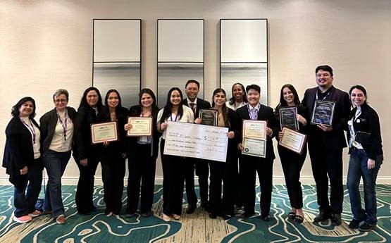 Group of conference attendees pose with awards.