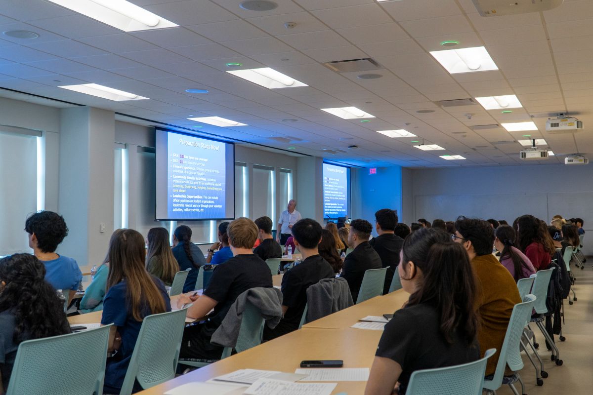 Classroom full of students listening to a presentation.