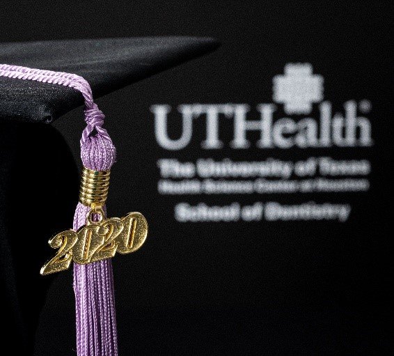 White UTHealth School of Dentistry logo on black background; lilac tassel with gold 2020 in foreground