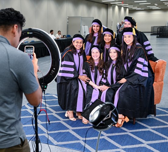 Graduates sit posed for a group photo.