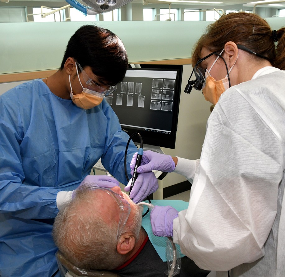 Dental Hygiene student learning with professor