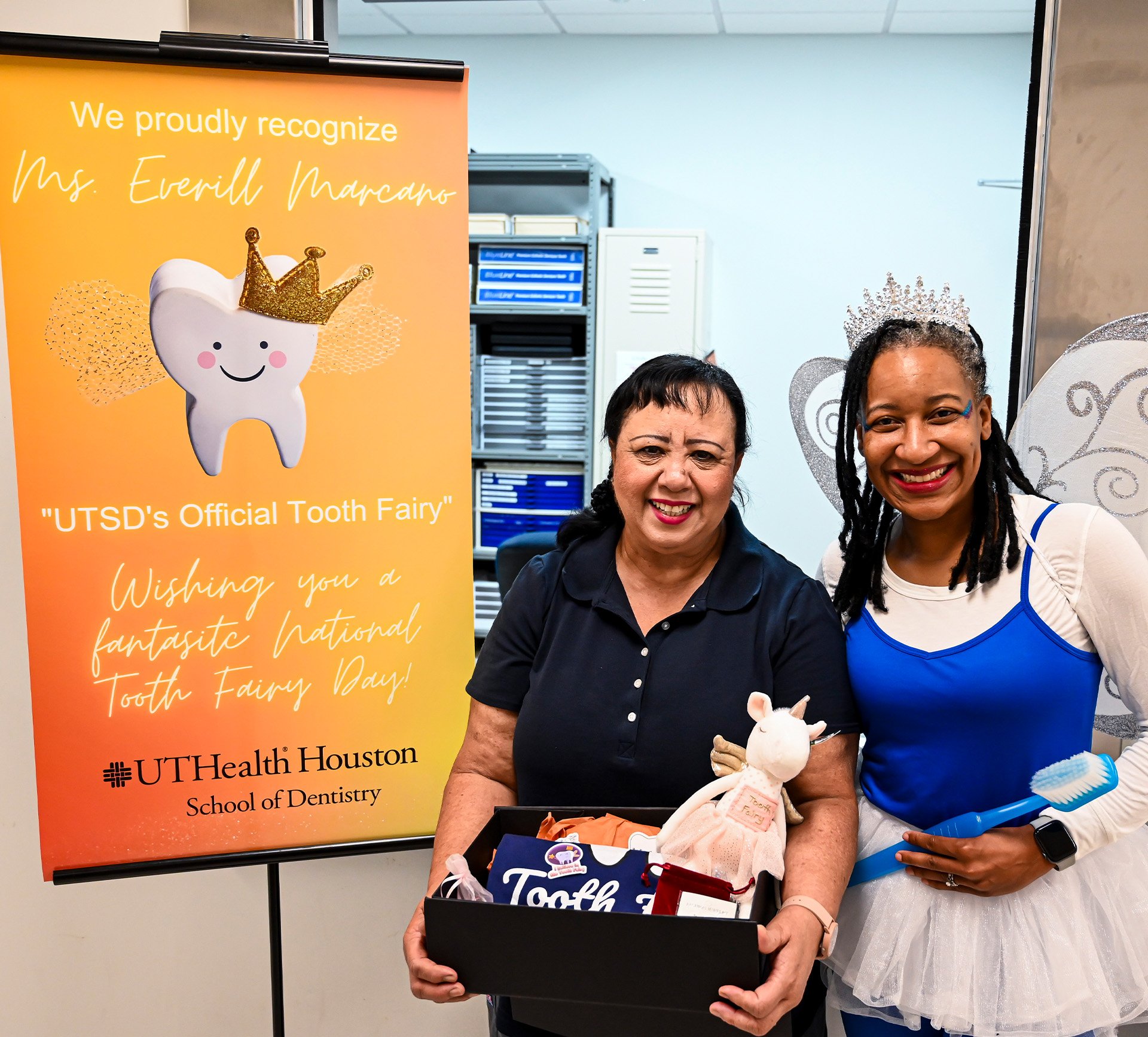 Everill Marcano (left), senior dental dispensaries assistant in the Tooth Room, was visited by the Tooth Fairy on National Tooth Fairy Day.