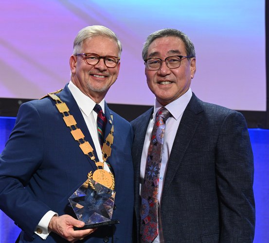 Professor Mark E. Wong, DDS (right), is presented the Robert V. Walker Distinguished Service Award by American Association of Oral and Maxillofacial Surgeons President J. David Johnson Jr., DDS.