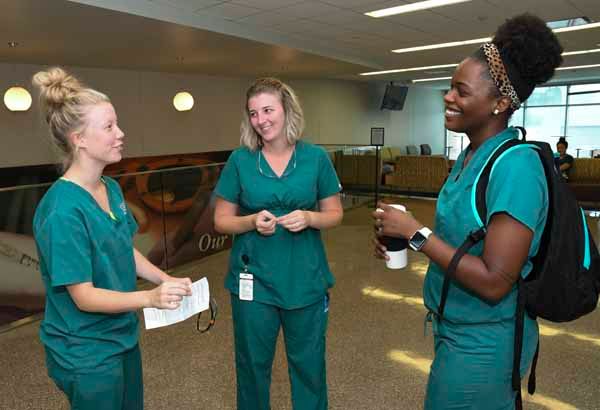 three dental hygiene students talking during a break