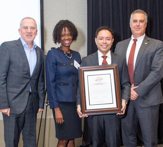 Dr. Harold Henson (middle right) holds his 2023 President’s Scholar Award for Excellence in Teaching.