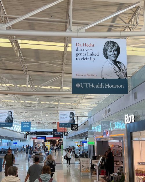 Banners hung inside an airport corridor.