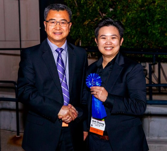 Dr. Anh Duong “Joy” Dang (right) presented the her award by Dr. Hai Zhang, chair of the John J. Sharry Prosthodontic Research Competition.